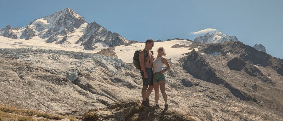 Richard and Tiffany standing close together on a ridge in the mountains above Chamonix